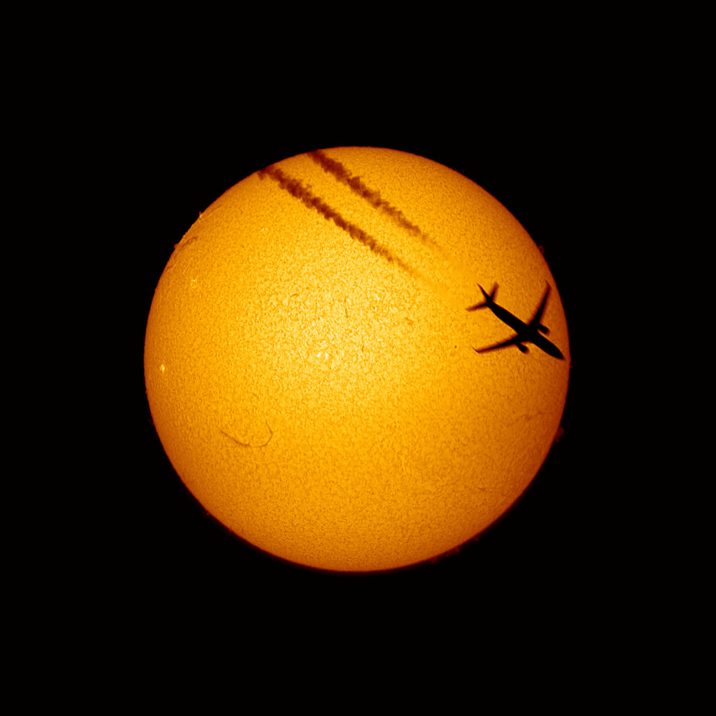 Airliner in front of Sun
