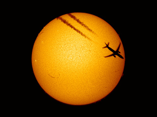 Airliner in front of Sun